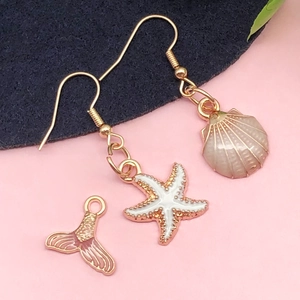 Ocean themed jewelry set with starfish, shell and mermaid tail charms in gold finish