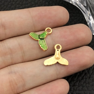 Detail of colorful enamel mermaid tail charms for DIY jewelry making and earring design