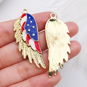 Macro shot of wing-shaped zinc alloy charm with American flag enamel for DIY jewelry