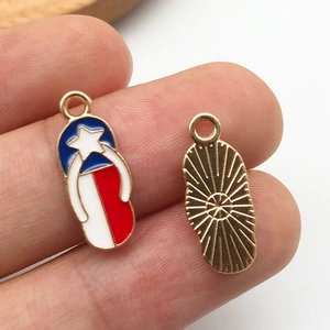 Macro shot of a flip-flop pendant with red white blue enamel stars and golden back