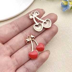 Detailed front and back view of red heart-shaped cherry alloy charms for DIY jewelry