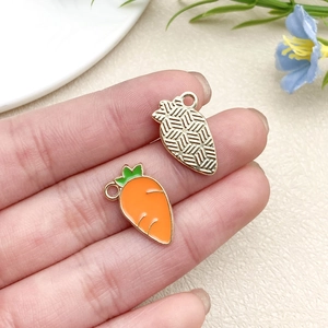 Macro view of handmade carrot-shaped alloy charms for DIY earrings and jewelry crafts