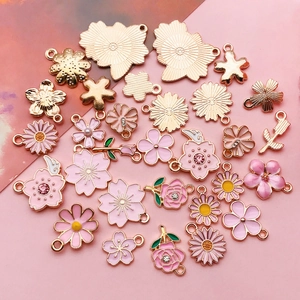 Pink enamel flower pendants for DIY jewelry making including cherry blossoms and daisies
