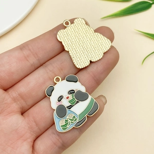 Detail of panda enamel charm showing intricate front design and textured gold metal back