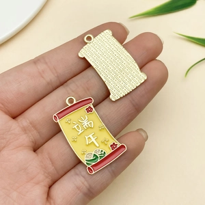 Detail of a gold dragon boat festival scroll pendant showing double-sided alloy texture