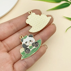 Detailed front and back of cartoon panda enamel pendant with gold textured backing