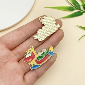 Macro view of dragon boat metal pendant showing front enamel and textured gold back