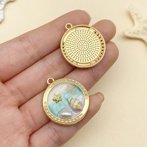 Detailed macro view of sea-inspired circular pendant showing resin art and starfish texture