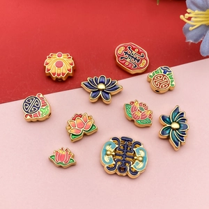 Detailed view of handmade enamel lotus beads and Fu charms for DIY jewelry making