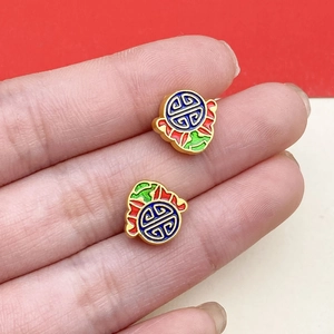 Macro shot of traditional cloisonné enamel lotus beads with gold trim and vibrant colors