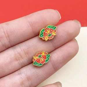 Detail of traditional cloisonne enamel lotus beads with vibrant colors and golden finish