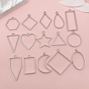 Flat lay of 15 silver geometric alloy open bezels for DIY resin jewelry making on pink background