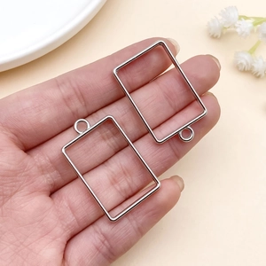 Detailed view of silver rectangular pendant frames for DIY resin jewelry making