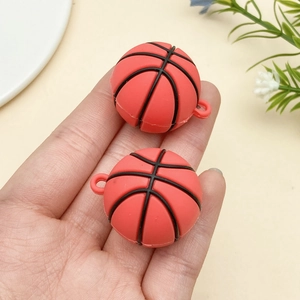 Close-up of orange PVC basketball pendants held in hand for DIY keychains