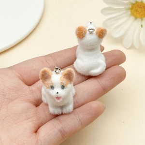 Close-up of a handmade flocked corgi dog pendant with a silver ring for DIY crafts