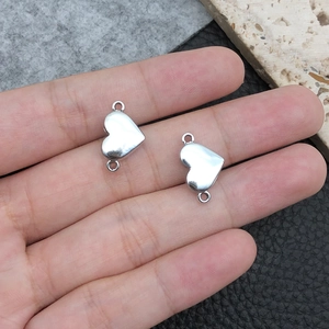 Macro shot of silver heart-shaped magnetic clasp connectors for DIY jewelry bracelets