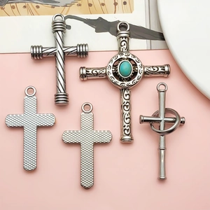 Lot de cinq pendentifs croix en argent avec motifs en relief et pierre turquoise