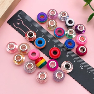 Macro shot of assorted colorful resin beads with large holes for DIY jewelry making