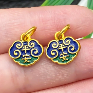 Macro detail of golden lucky cloud charms with Ping An relief and enamel inlay