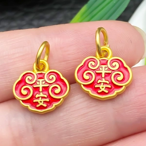 Macro shot of Ruyi lock charms with red enamel and Ping An engraving on fingertips