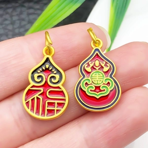 Macro shot of traditional Chinese gold gourd pendants with colorful enamel inlay and Fuk character