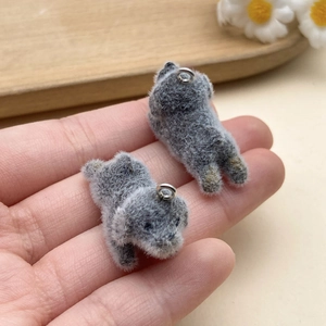 Detail of gray flocked puppy pendant charms showing soft texture and compact size