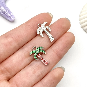 Detail of palm tree alloy charms with silver finish and colorful oil drip enamel work