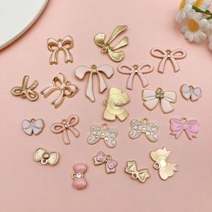 Pink enamel bow charms collection with gold alloy accents for DIY jewelry making