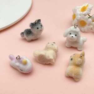 Five cute cartoon flocked resin animal pendants including cat and unicorn on pink background