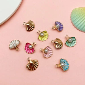 Detail of colorful seashell charms with faux pearls for DIY jewelry making and necklaces