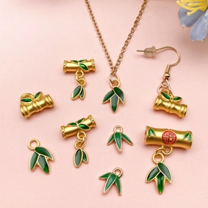 Oriental style gold bamboo leaf jewelry charms with green enamel and Fu character