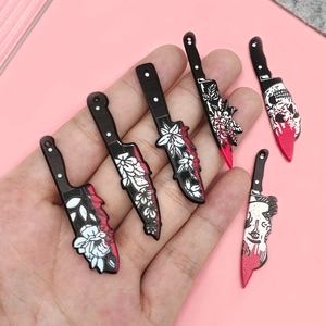 Quirky acrylic knife charms for DIY jewelry featuring skulls and artistic patterns