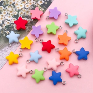 Macro detail of colorful resin star pendants with silver metal rings for DIY jewelry making