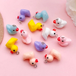Macro view of assorted resin duck pendants in pastel colors for DIY jewelry crafts