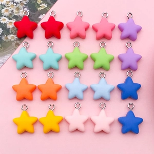 Macro detail of colorful star pendants with metal rings for DIY jewelry making and crafts