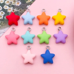 Flat lay of colorful resin star charms in ten matte shades with silver hooks for DIY jewelry