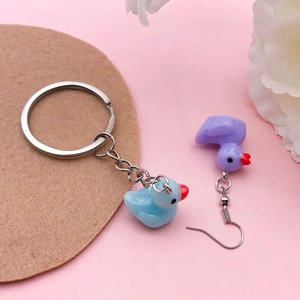 Mini resin duck keychain and earrings set in light blue and purple cartoon styles
