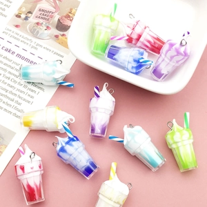 Macro shot of colorful resin ice cream charms with straws and metal rings for DIY jewelry