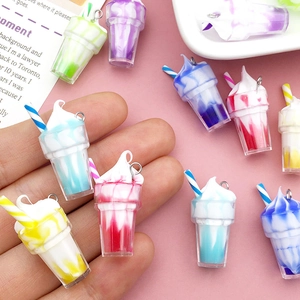 Close-up of colorful resin ice cream charm pendants with cream texture and straws