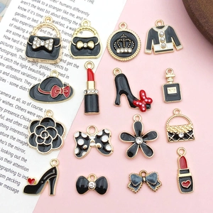 Detail of alloy charms with black enamel, rhinestones and pearls for DIY hair accessories