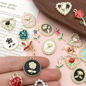 DIY rose flower pendants with enamel and pearls on elegant vintage background
