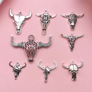 Set of eight antique silver bull head charms with intricate bohemian carving for DIY jewelry