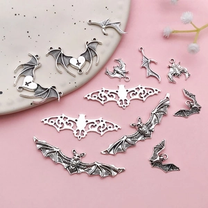 Set of silver-toned bat pendants in various designs for DIY Halloween jewelry making