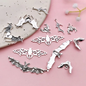 Detailed view of assorted antique silver bat charms for DIY gothic jewelry making