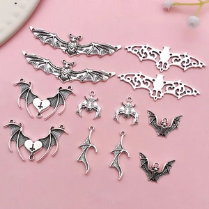 Detailed flat lay of assorted antique silver bat charms for DIY jewelry making