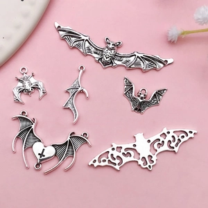 Detail shot of six antique silver bat alloy charms for DIY Halloween jewelry making