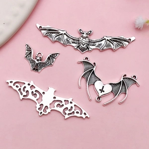 Four vintage silver bat charms in various styles for Halloween DIY jewelry making