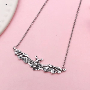 Antique silver bat pendant necklace with detailed wings on a minimal chain