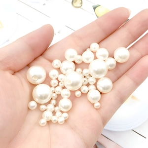 Macro shot of assorted cream ABS faux pearls with holes for DIY jewelry making