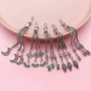 Detailed macro view of retro silver moon and flower tassels for DIY jewelry crafts